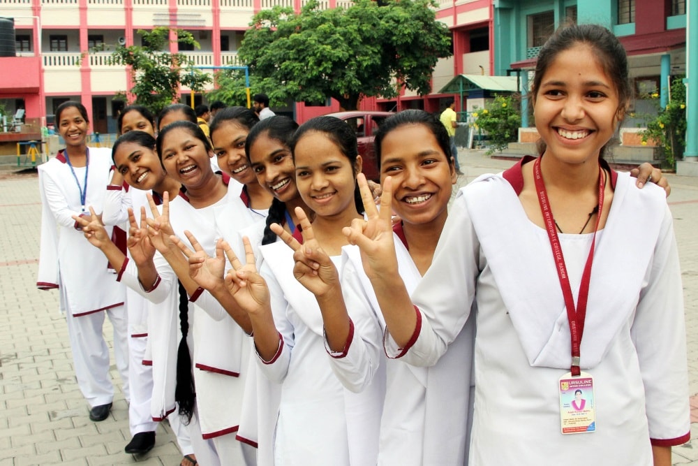 <p>Students of Ursuline Convent showing victory sign as they celebrate their success after the declaration of Jharkhand Academic Council (JAC) intermediate results at their school…