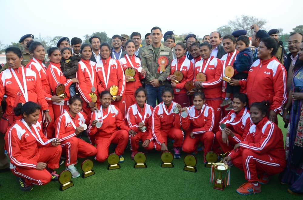 <p>Cricketer Mahendra Singh Dhoni and Central Railway Hockey players pose for photo during concluding day ceremony of the 39th All India Railway Women's  Hockey Championship…