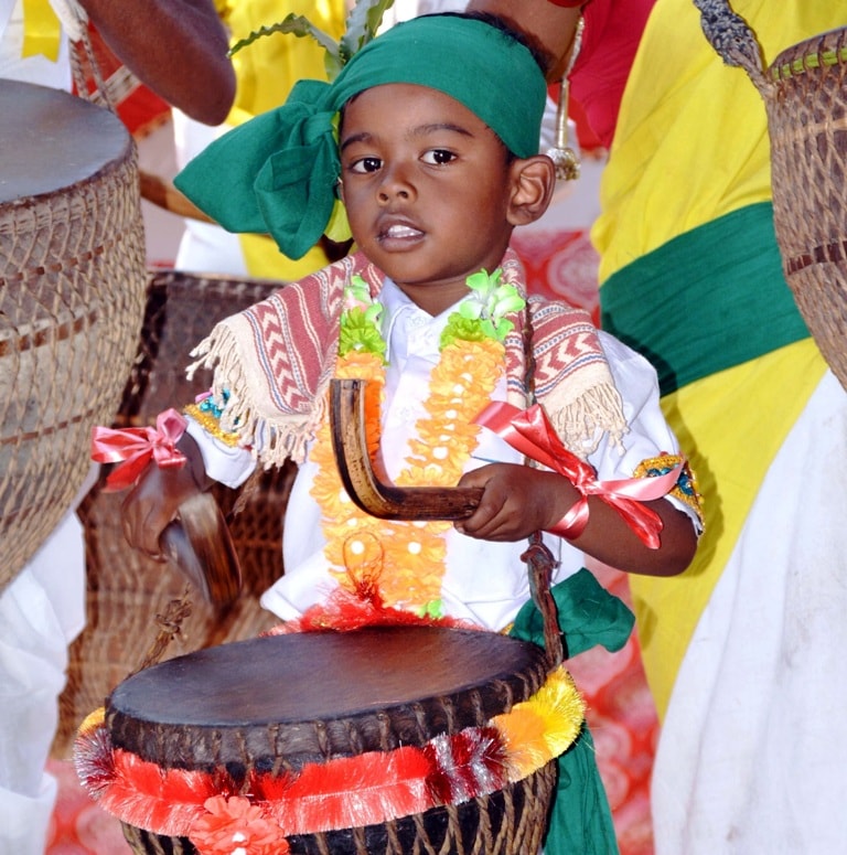 <p>A kid dressed in traditional attire seen beating 'mandar' - a traditional musical drum during the Sarhul festival celebrations in Ranchi on Tuesday.</p>
