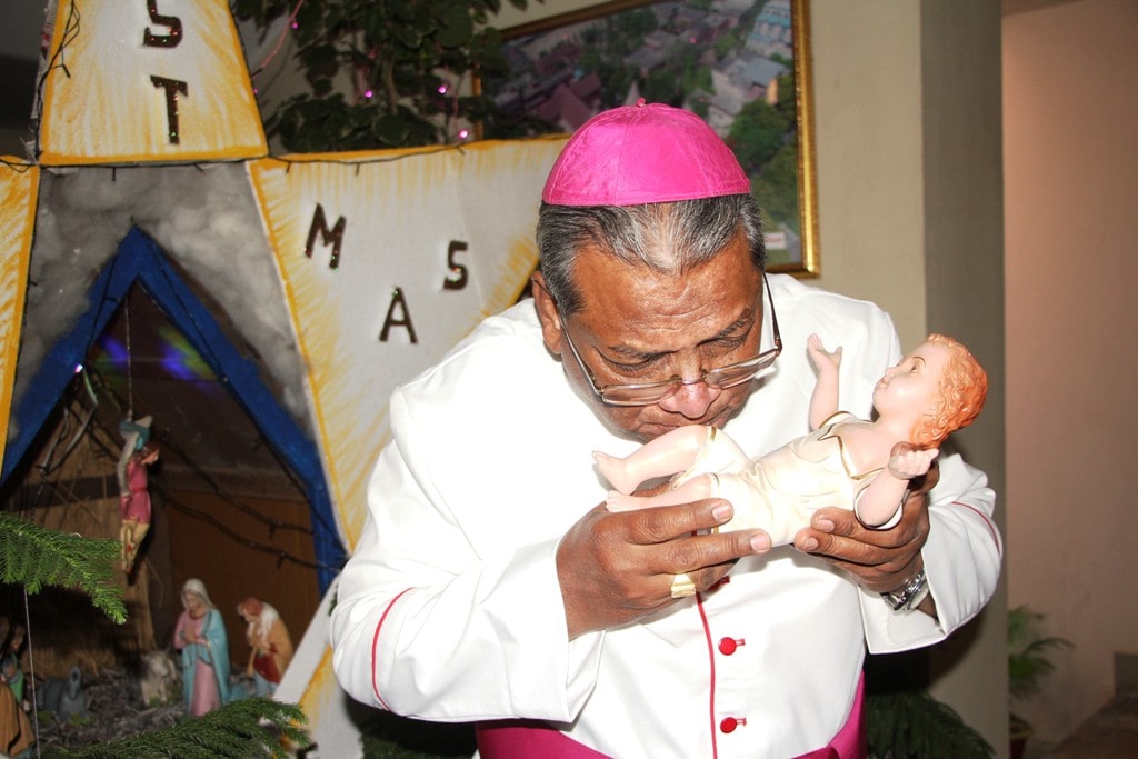 <p>Archbishop of Roman Catholic Felix Toppo S.J. kisses a statue of baby Jesus as he celebrated of Christmas eve in Ranchi on Monday.</p>
