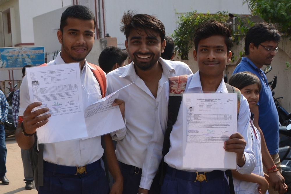 <p>Students showing their admit cards as they arrive at a center for appearing in the CBSE board examinations in Ranchi on Monday.</p>
