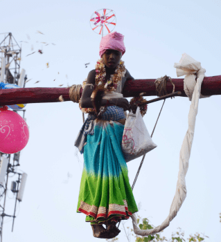 <p>People watch acrobatics being performed by a devotee during the Manda festival in Ranchi on Friday.</p>
