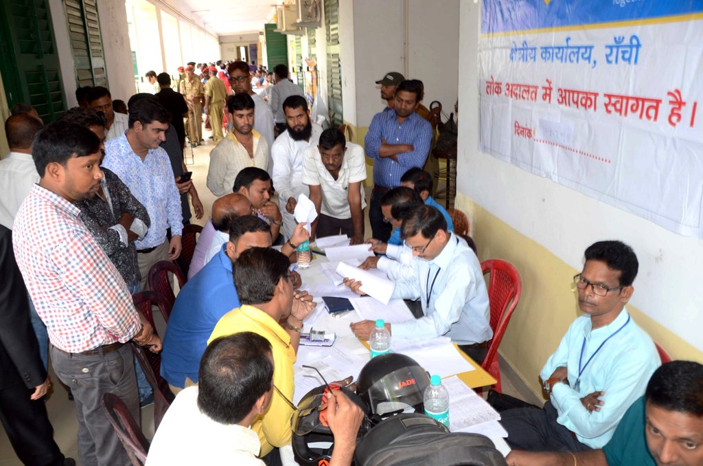 <p>Lawyers solving the cases of people during Mega National Lok Adalat at Civil court in Ranchi on Saturday.</p>
