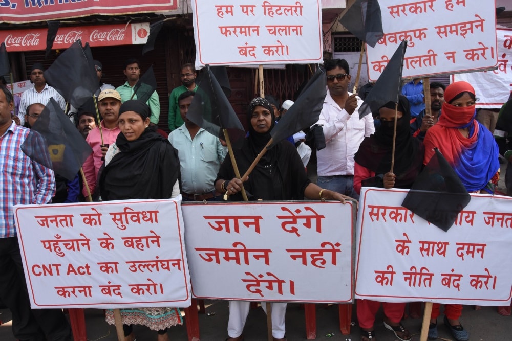 <p>Local people protest by showing placards and shouting slogans against the construction of proposed Kantatoli flyover in Ranchi on Monday.</p>

